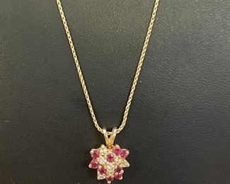14k Gold Necklace with Heart Shaped pendant set with rubies and sapphires total weight is 3.38 grams
