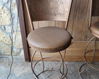 (8) Western Style Metal Bar Stools
With roping cowboy stamped on backs
Unique, hinged feature allows seatbacks to fold down so you can use these stools with or without the backs. 
31in to seat and 49.75 to top of back