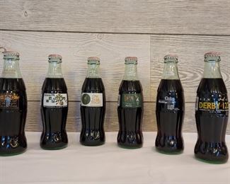 (5) Commemorative Coke Bottles From the 1990’s include: 3 Atlanta Olympics, 1 Kentucky Derby Derby, and 1 Dallas World Cup