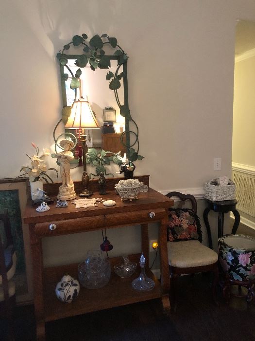Gorgeous antique table, green ivy mirror, side tables, set of four white bottom chairs, and many beautiful, pristine collectibles.