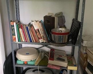 metal bookshelf and electric roaster, bakeware, cook books in the sewing room 