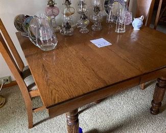 Dining table made by Robbins Table Co., Owosso. Has 6 self storing leaves. Family heirloom