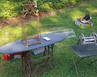 Singer base, slate top credenza or foyer table, with part of an old churn setting atop. 