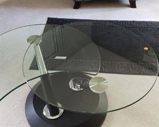 Contemporary swivel glass top coffee table