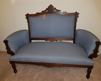 Antique Upholstered Sofa wood highlights.