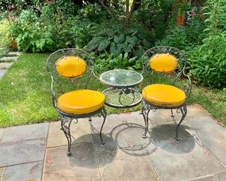 Vintage wrought iron tete-a-tete detail. Table can accommodate a patio umbrella.
