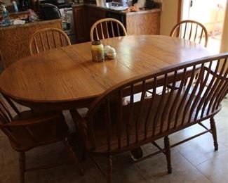 Round oak 48" table with two 12" leaves. Single pedestal. Purchased at Whitaker's in Hudson, IL