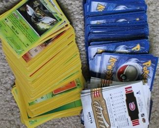 Pokemon cards and a few sports cards - all cards have been bundled into bags of quantity