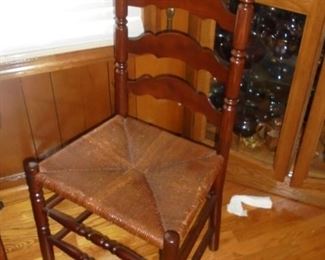 1 of 4 matching ladder back woven seat chairs