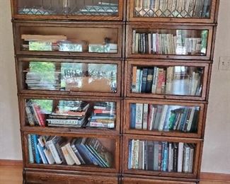two barrister bookcases with lead glass, books and pottery pieces