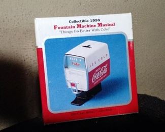 1958 collectable Musical Coca Cola Fountain Machine. This beautiful miniature Coca-Cola Soda Fountain also has a musical feature and comes with it's own COA. It's a real eye catching Red/White replica of the 1958 soda fountains for your home or office. When you insert batteries in the compartment and pull the dispenser handle it plays a clip of the iconic Coke song "Things Go Better With Coke". It's details are a thing of beauty and looks like it was handmade by craftsmen with care.