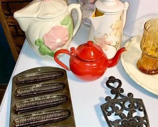 Lodge cast iron corn bread pain, cast iron trivets, small enamel teapot, stoneware teapot, ceramic teapot, etc.