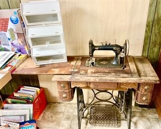 Antique treadle sewing machine, cabinet is rough, kid's books