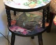 CLEARANCE !  $3.00 NOW, WAS $10.00.................Round Table Bought at a tag sale in Connecticut, circa 1989
Diameter is 15”, height is 24”
Our daughter covered the two surfaces of the table with a collage she made. I imagine one could remove it