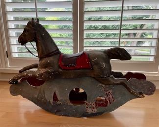 CLEARANCE !  $250.00 NOW, WAS $600.00..................Antique Rocking Horse, belonged to Grazia’s dad when he was a child in the Sicilian town of Messina, Italy. 
Base is wood, horse is some kind of plaster
Rocking Horse: 39.5”L x 7”W x 25”H                                Slight damage from our puppies on the two posterior horse hooves. Color has been scraped off in several spots. 