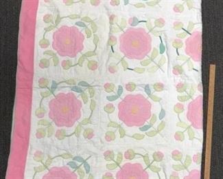 Pink and white flower pattern quilt