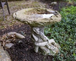Same as previous image. Large concrete bird bath