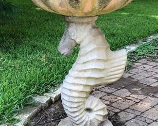 Concrete seahorse birdbath