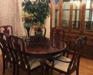 Solid wood dining table with leaf and 6 chairs.
