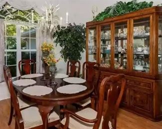 Solid wood dining table with leaf and 6 chairs, lighted china cabinet. Greenery is available.