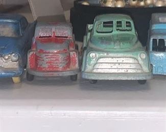 Collection of vintage toy trucks and cars.