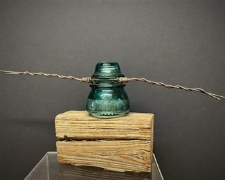 Glass insulator mounted on wood block with wire attached ...To Register and To Bid go to https://capitolsalesservices.hibid.com 