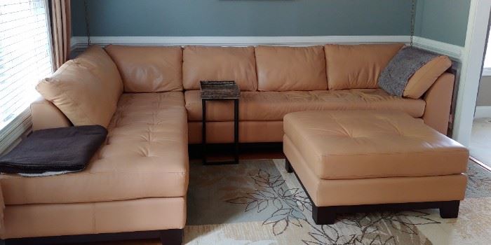 Tan leather sectional sofa and ottoman