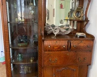 Antique Oak Cabinet with curved glass display cabinet, drawers and cabinet for storage and display. This piece is so versatile for any space. It is just perfect to display most any collection from vintage cameras, clocks, rocks, shells, books, china, crystal or bar ware. Your collection will be elevated featured in this cabinet!