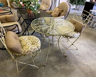 Wrought iron bistros wit cushions.