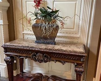 Faux marble top table with carved legs.