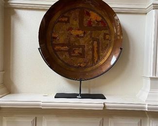 Huge plate on metal stand.