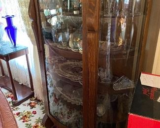 Curved glass footed curio cabinet