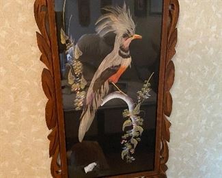 Ornate wood frame of bird made of real feathers
