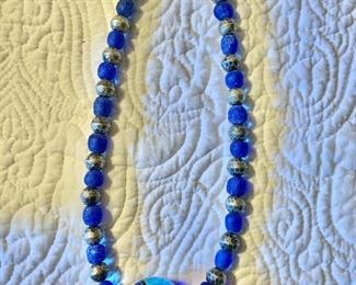 $35 Blue glass necklace 16" long 