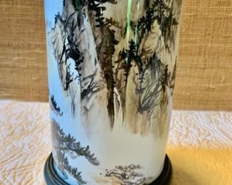 $75   Brush wash cylindrical  porcelain vase on carved wood stand.  8" H, 4.5" diam.