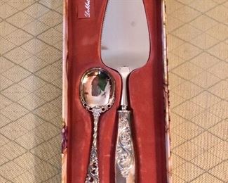 $75 830 Silver cake knife and spoon in original box.  Cake knife 10" L, spoon 5.25" L. 