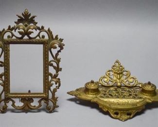 36	Brass Desktop Items	Decorative filigree picture frame and decorative inkwell adorned with a grotesque. Frame is marked on the verso on lower left with 08576 and 8 on lower right. Some chipping. Largest object measures 13.5" L x 9.5" W x 3.5" H.
