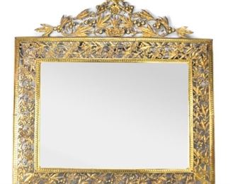61	Ornamental Brass Mirror	A beveled mirror with floral filigree brass frame and arched ornament topper. Good condition with some wear consistent with its age. 27.5" L x 28.5" H
