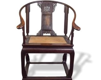 63	Carved Chinese Horseshoe Armchair	Carved Chinese armchair with horseshoe back and woven seats. 31 1/4"W x 23"D x 44"H. Section of carving missing from splat.
