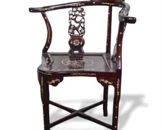 64	Carved & Inlaid Chinese Rosewood Corner Chair	Carved rosewood Chinese corner armchair, with horseshoe back and mother-of-pearl inlays throughout. 30 1/2"W x 23"D x 35"H. Small chip at front of seat.
