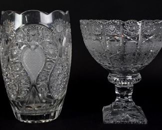 84	Two Pieces of Cut Glass	Two pieces of cut glass, including a Goda crystal vase with cut heart and hobstar motifs, and a crystal bowl on pedestal with hobstars and crosshatch designs, unsigned. Goda is signed just above the base. Largest item is 12" H x 7 1/2" Diameter.
