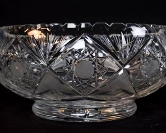 86	Cut Glass Bowl	Large cut glass bowl. 5 1/2"H x 11 1/2"-diameter. Chips and flea bites throughout.

