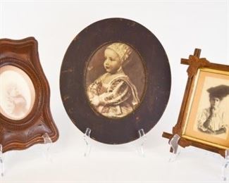 107	Print & 2 Photos in Carved Wood Frames	Portrait of a woman in carved Adirondack frame with leaf decoration, photograph 4 3/4" x 4", frame 12 1/2" x 10 3/4"; portrait of a woman in carved frame, 5 1/4" x 3 3/4", frame 13" x 9" (chips), print of a portrait of a baby in circular frame, 9 1/2" x 7 1/2", frame 15 3/4" x 13 3/4"
