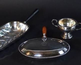116	Silver & Silverplate Grouping	Arrowsmith weighted sterling footed sugar and creamer; Sheffield Silver Co. banana leaf silverplate tray with wooden handle, silverplate silent butler with wooden handle. Sugar bowl 3"H, banana leaf tray 16"L including handle. Dents to bases of sugar and creamer.
