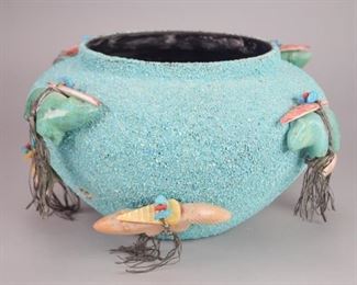 135	Zuni Fetish Bowl	Zuni pottery bowl with crushed turquoise coating. 8 fetishes affixed to the outside, with 1 additional loose fetish. 7 1/2"H x 11 1/2"-diameter

