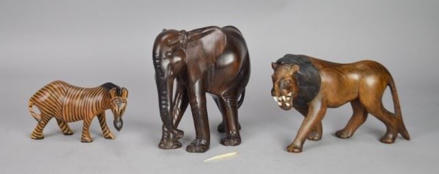 137	3 Carved Wood Animals	3 carved wood animals: zebra, lion and elephant. Elephant 9"L x 8 1/2"H. Elephant missing 1 tusk, 1 tusk loose, chips to lion's teeth.

