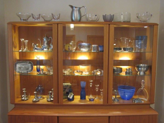 Gorgeous lighted Danish modern teak china cabinet from Nordic Furniture.  Lots of art glass - Orrefors, Konge-Tinn pewter and more...