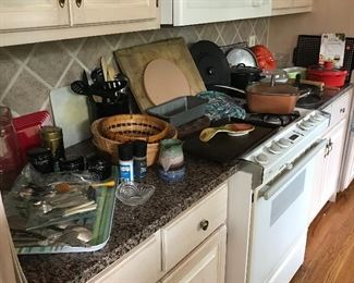 Flatware, copper skillet with lid, wood cutting board, and more kitchen cookware