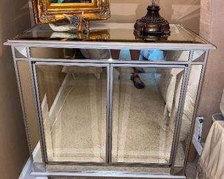 Mirror-covered night stand.