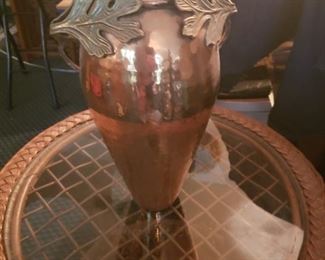 Copper vase with bronze leaves on the top
